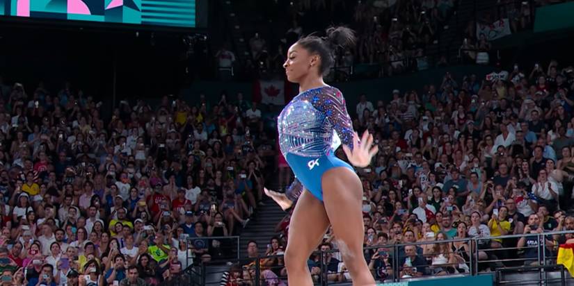 Simone Biles on Beam in Simone Biles Rising with her hands out