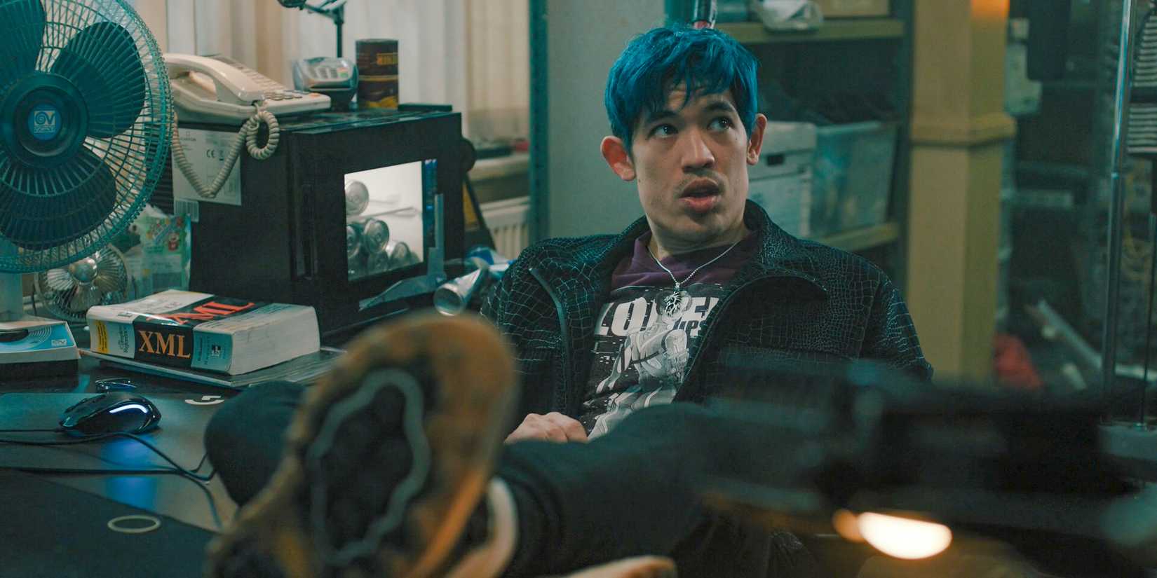 Roddy Ho (Christopher Chung) with his feet on the desk in Slow Horses Season 4 Episode 5