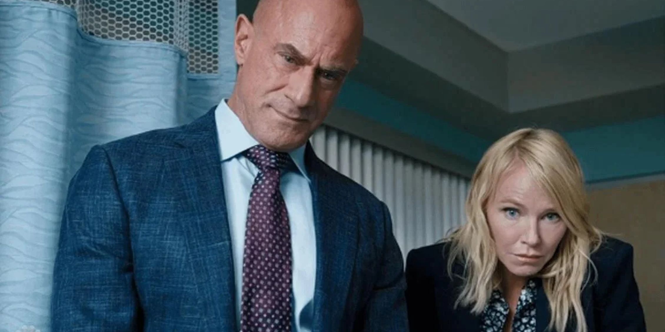 Law & Order: Organized Crime Rollins leaning over to look at evidence with Stabler