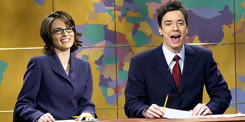 Tina Fey and Jimmy Fallon smiling at the Weekend Update desk on SNL season 26