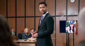 Mickey stands in the courtroom with a picture of Glory Days in the background in The Lincoln Lawyer season 3 episode 6