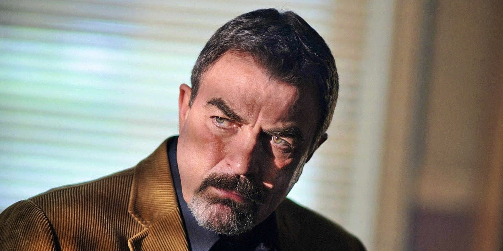 Tom Selleck brooding as Jesse Stone with light shining through blinds onto him