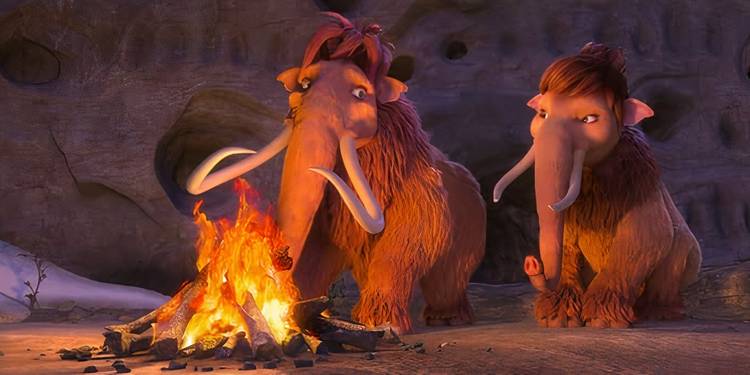 Ellie and Peaches sitting around a roaring fire together in Ice Age: Collision Course.