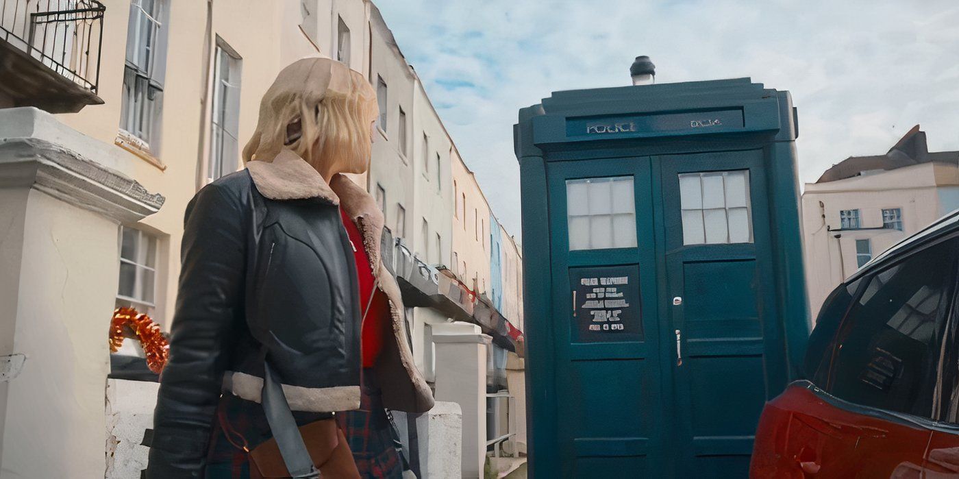 Millie Gibson as Ruby Sunday looking back at the TARDIS in the street, while talking to Mrs. Flood off-screen, in the Doctor Who episode The Church on Ruby Road.