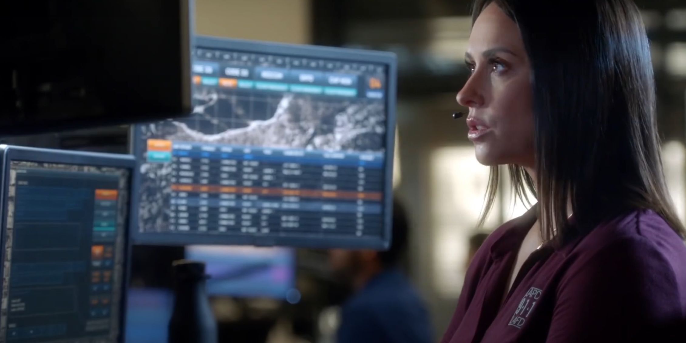 9-1-1 a dispatcher staring at a monitor and taking a call
