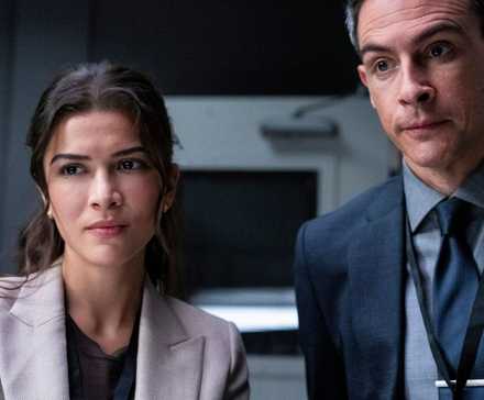 Syd and Scola standing together and looking straight ahead in FBI season 7