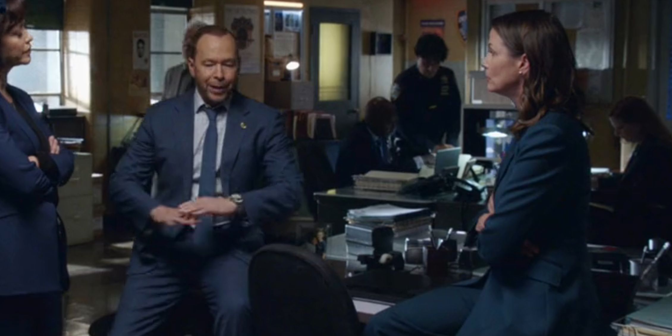 Blue Bloods Erin in the squad room with Danny and Baez who seem tense