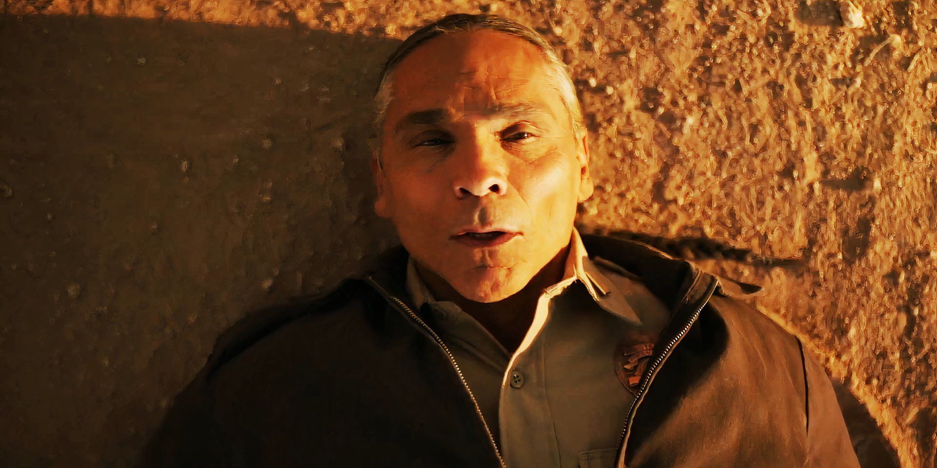 A still from the Dark Winds season 2 teaser with Lt. Joe Leaphorn laying on the ground