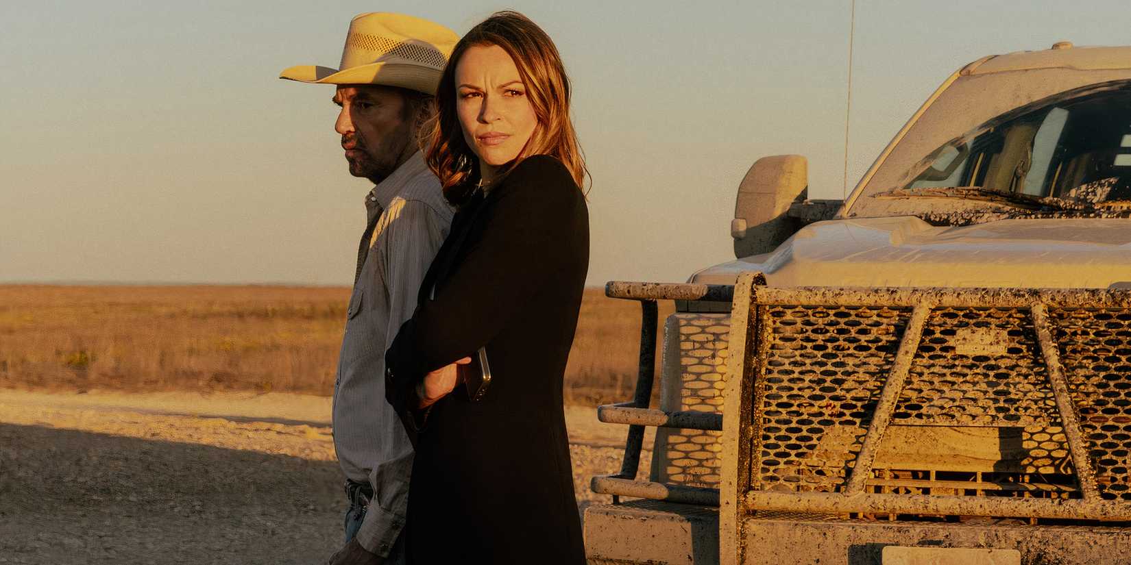 Billy Bob Thornton as Tommy and Kayla Wallace as Rebecca standing next to a truck in Landman