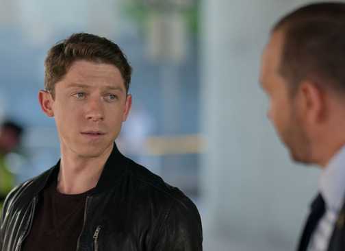 Blue Bloods Danny and Joe looking at each other at a crime scene