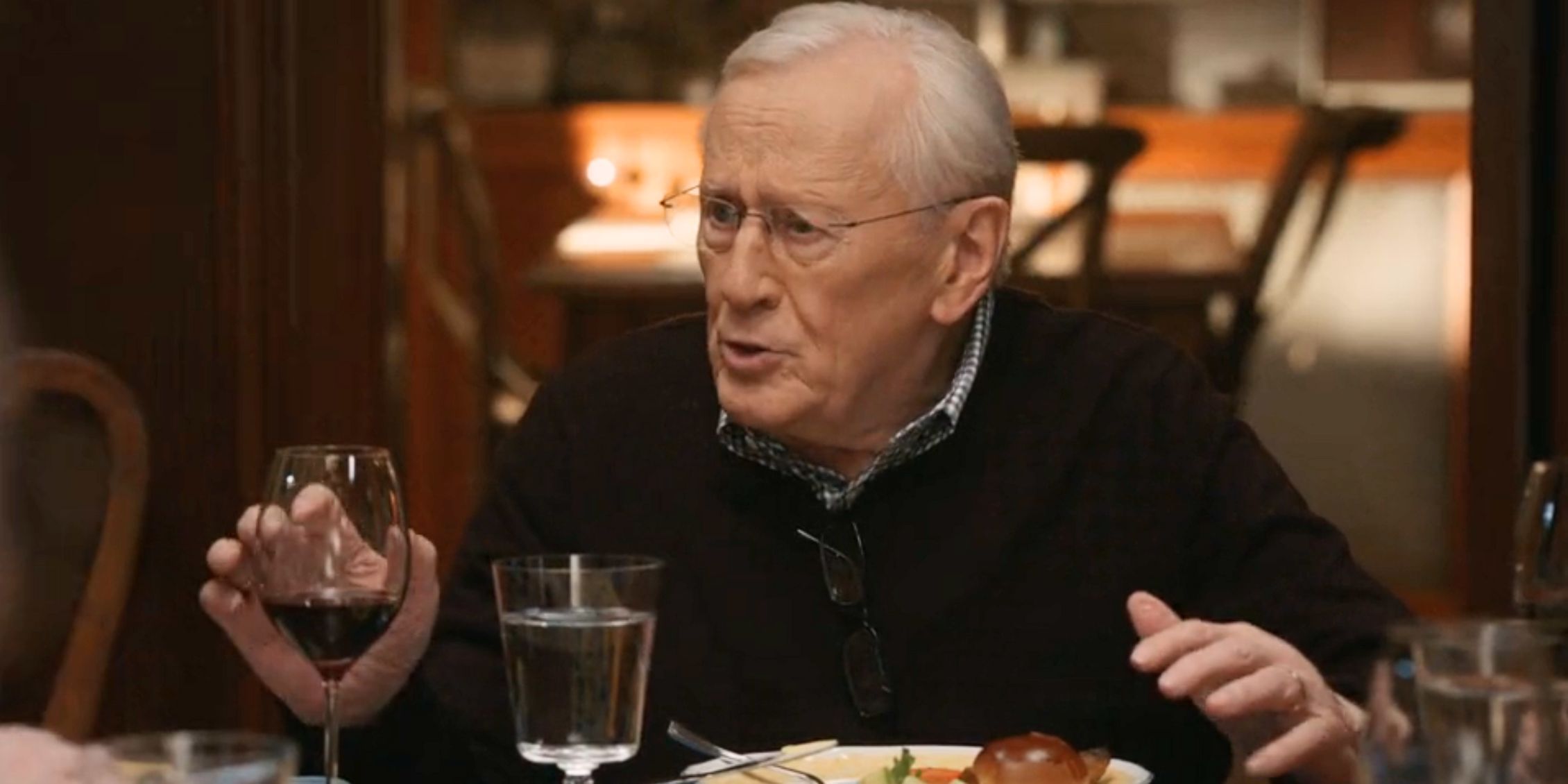 Henry sitting at the family dinner table making a point in Blue Bloods