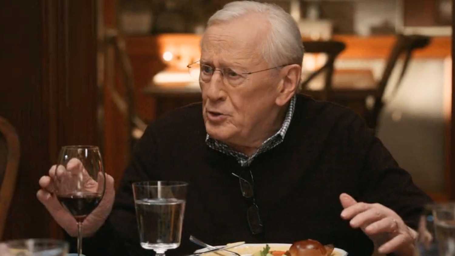 Henry sitting at the family dinner table making a point in Blue Bloods