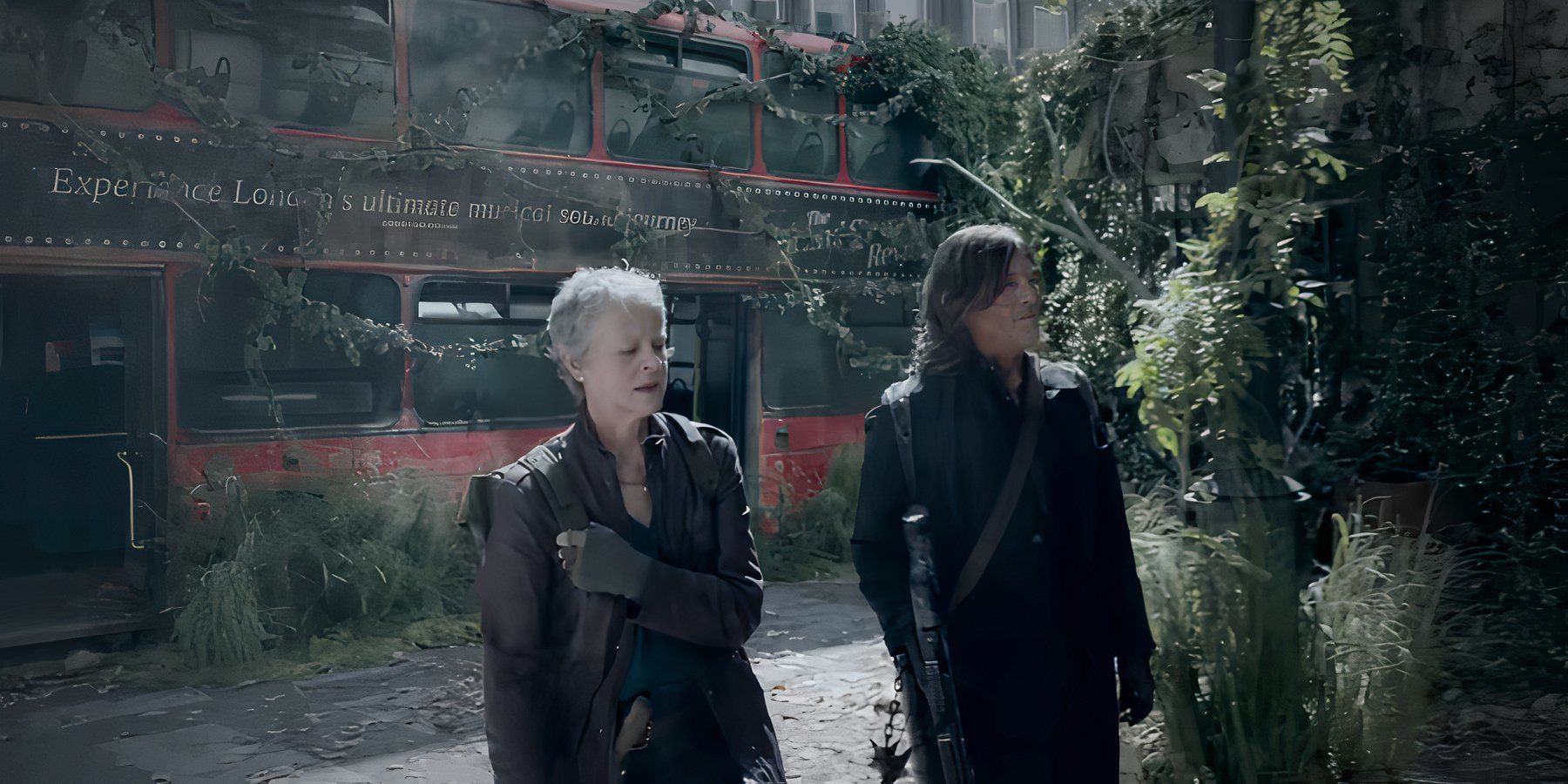 Carol (Melissa McBride) and Daryl (Norman Reedus) walking in front of a mossy bus in The Walking Dead: Daryl Dixon.