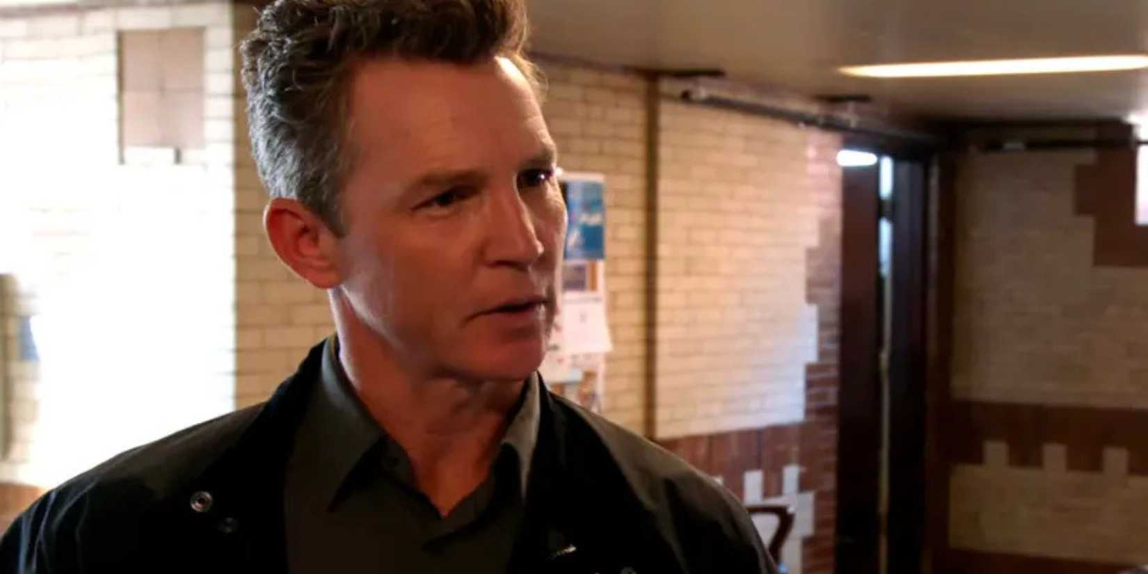 Reid standing in the squad room in Chicago PD