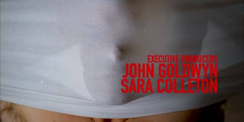 Dexter is pictured pulling a white t-shirt over his head; the imprint of his face is visible through the fabric.