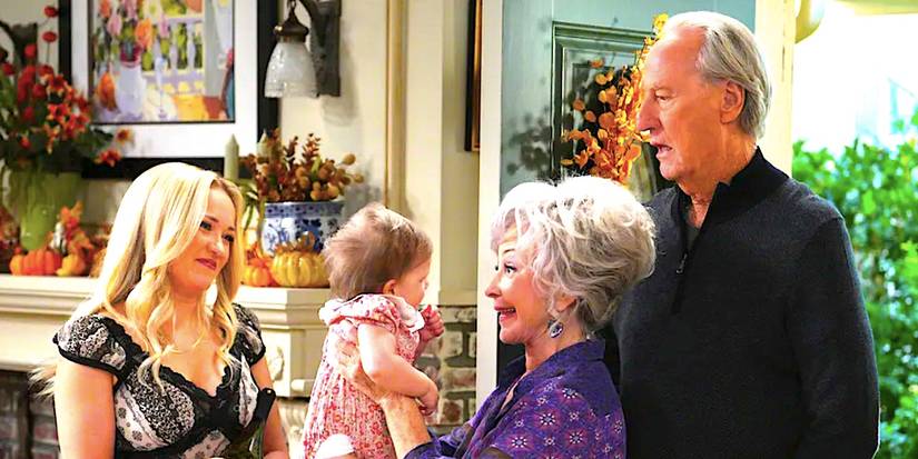 Emily Osment's Mandy smiles while Annie Potts' Meemaw holds her baby Cece and Craig T Nelson's Dale stands in a doorway from Georgie & Mandy's First Marriage episode 5