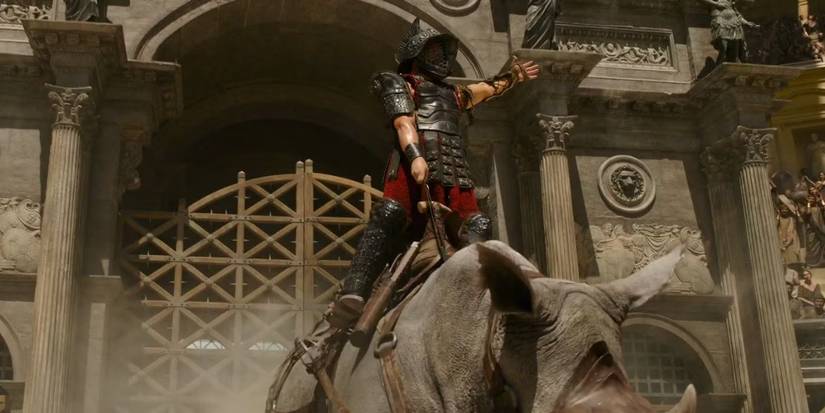 A gladiator riding a rhino in Gladiator II