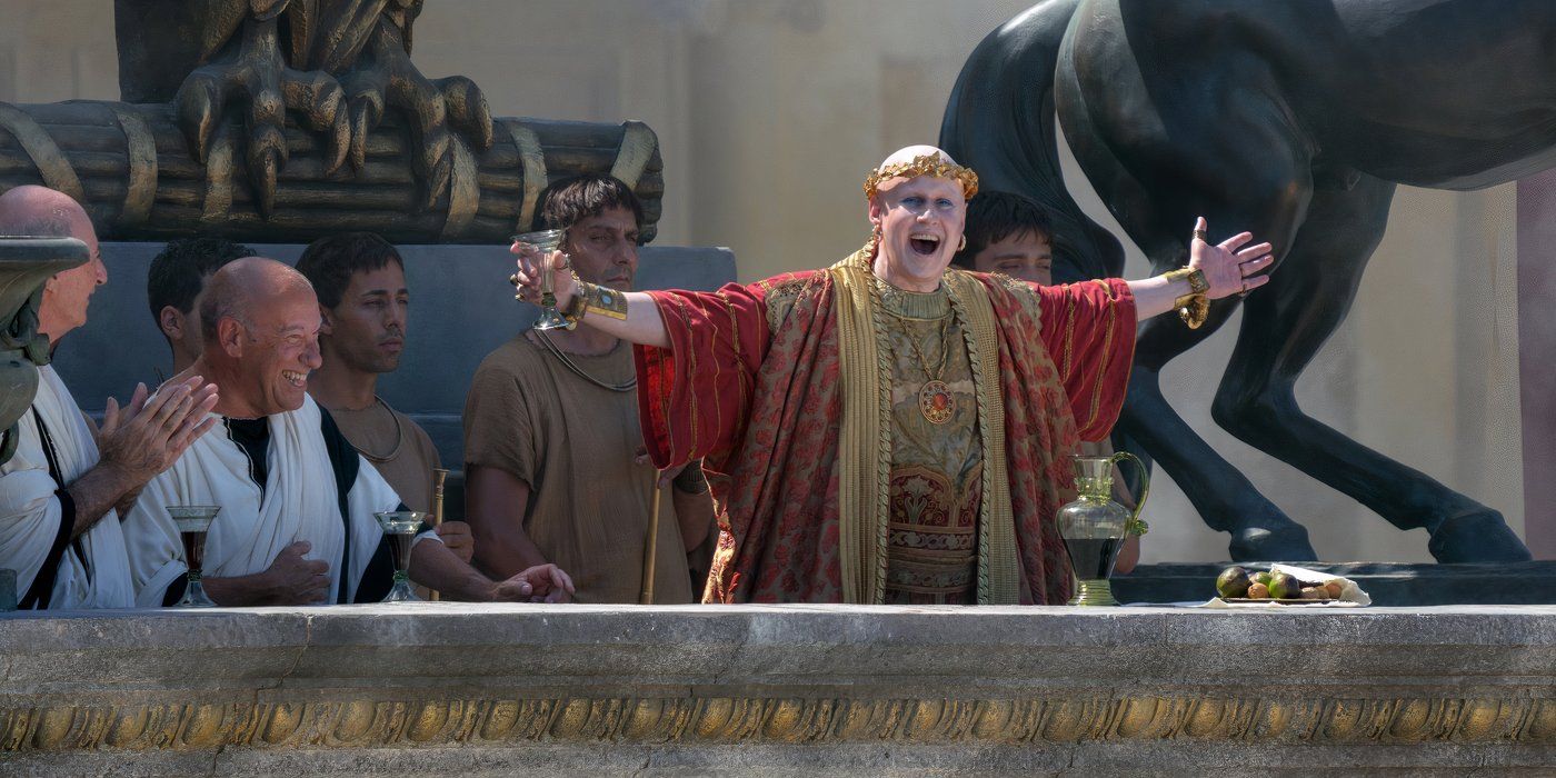 Matt Lucas as Master Of Ceremonies raising his arms Gladiator II 