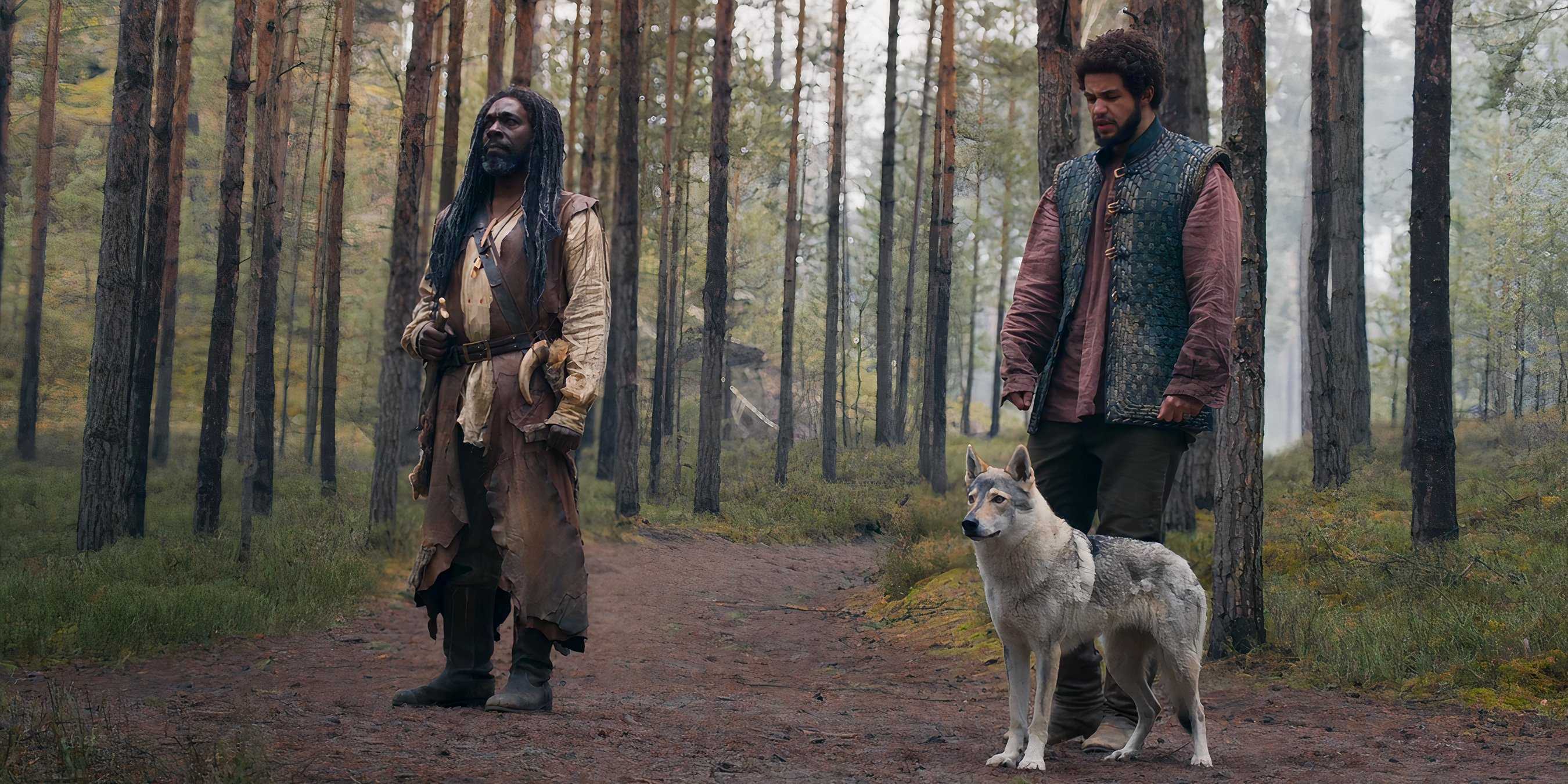 Elyas Machera, Perrin Aybara, and Hopper the Wolf standing in the woods in The Wheel of Time
