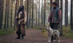 Elyas Machera, Perrin Aybara, and Hopper the Wolf standing in the woods in The Wheel of Time