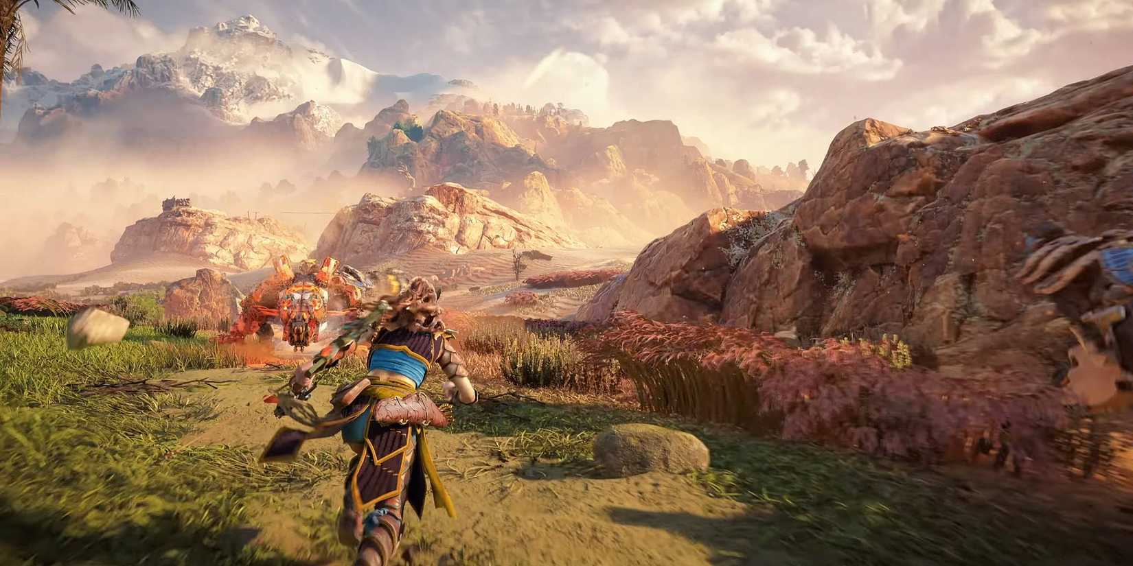Aloy running in Carja armor across a field in Horizon Zero Dawn Remastered.