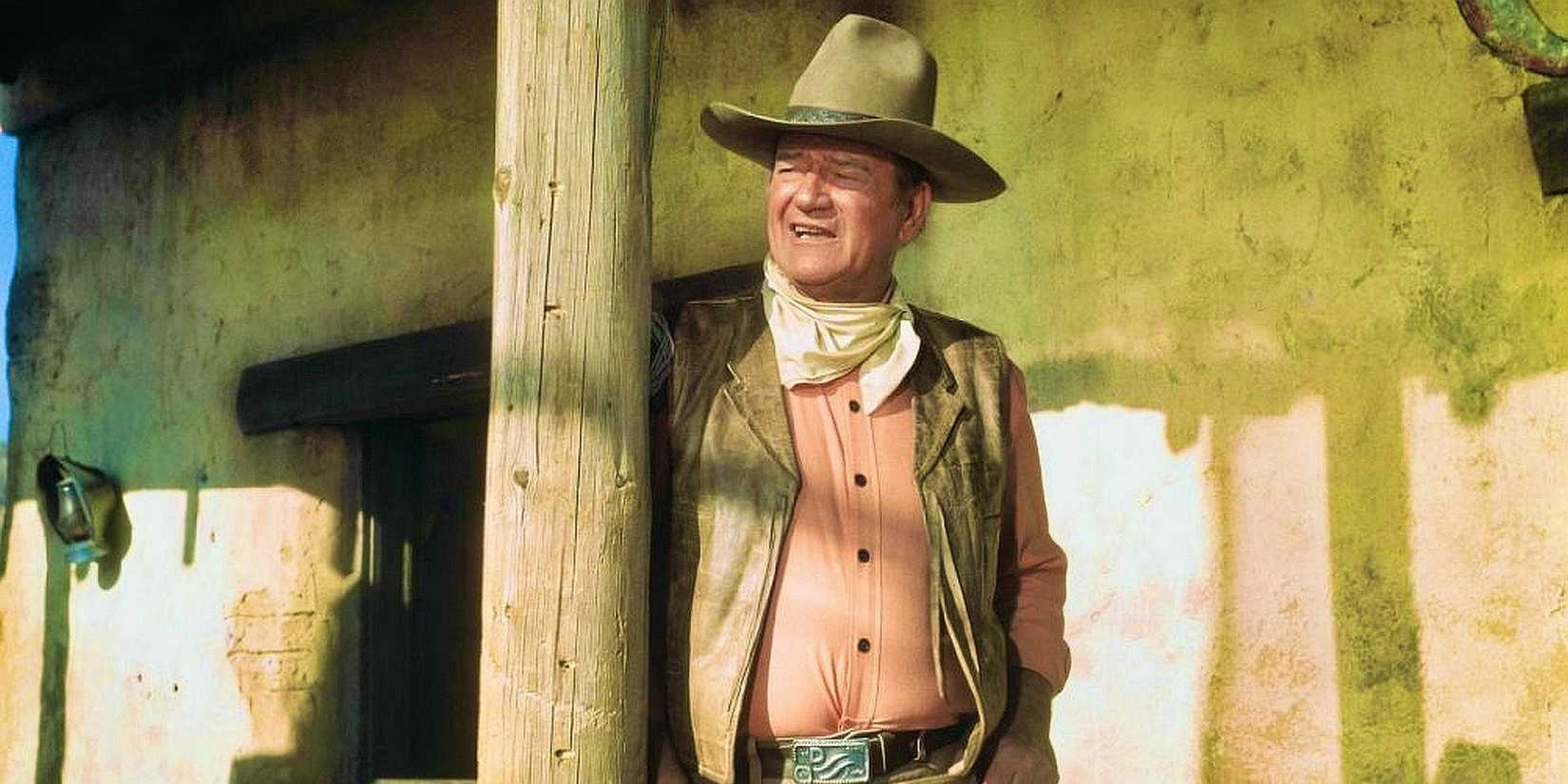John Wayne leaning against a post as Cord in Rio Lobo