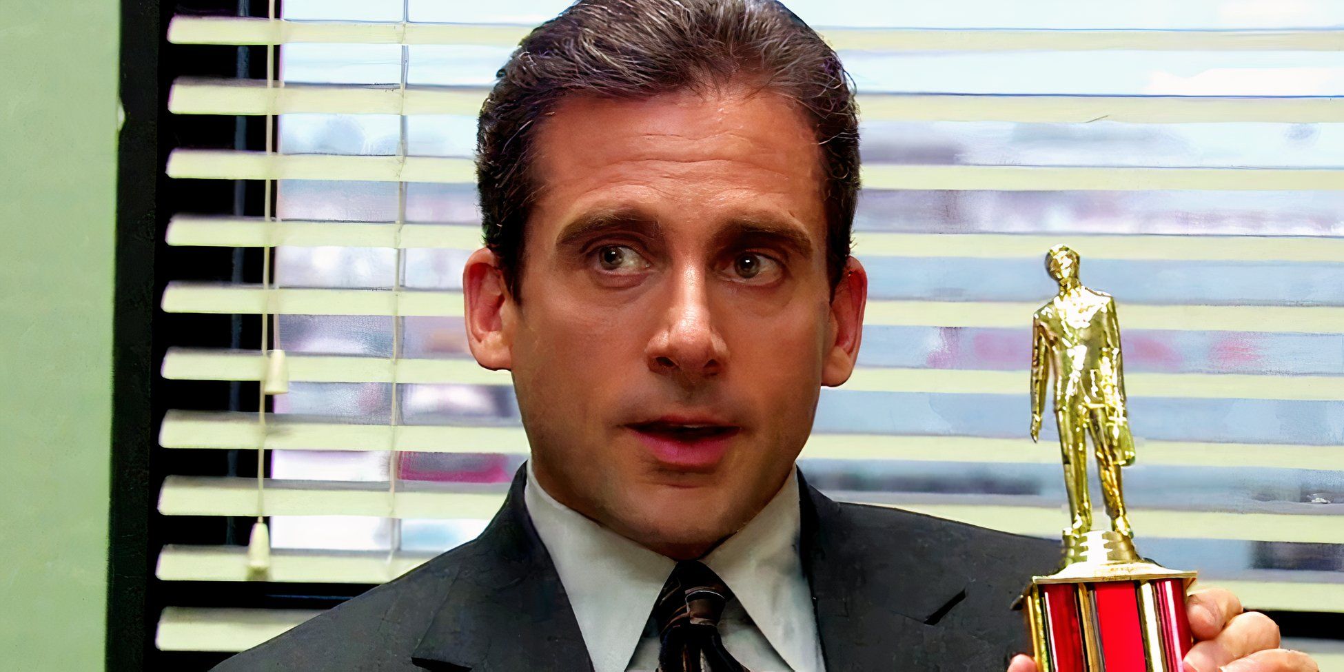 Michael Scott (Steve Carell) holding a Dundie award in The Office