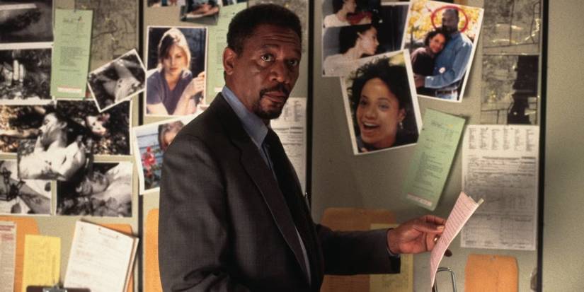 Morgan Freeman as Alex Cross looking at pictures in Kiss the Girls