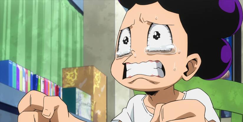 Mineta crying as he watches All Might on TV.