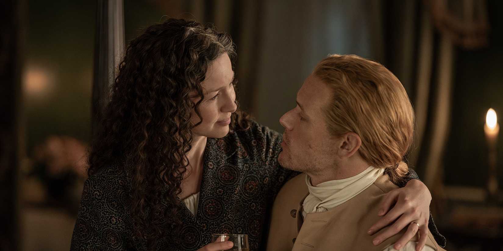 Claire sitting on Jamie's lap in Outlander season 7
