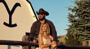 Rip and Beth sitting on the cow pen fence in front of the barn in Yellowstone season 5 part 2