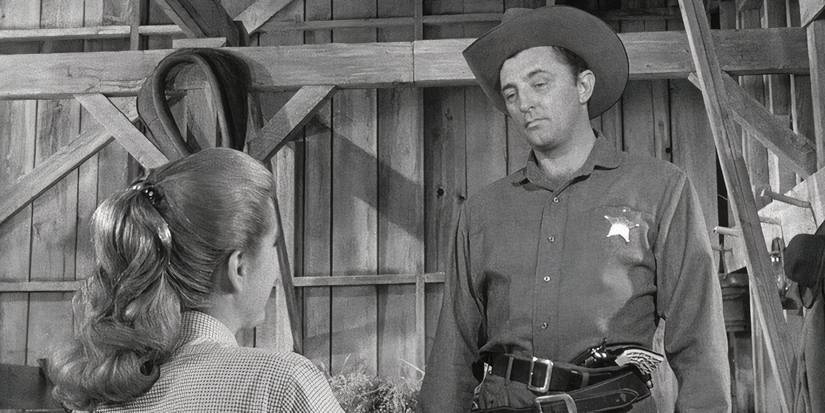 Robert Mitchum em O Homem com a Arma