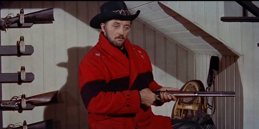 Robert Mitchum holding a rifle in Track of the Cat
