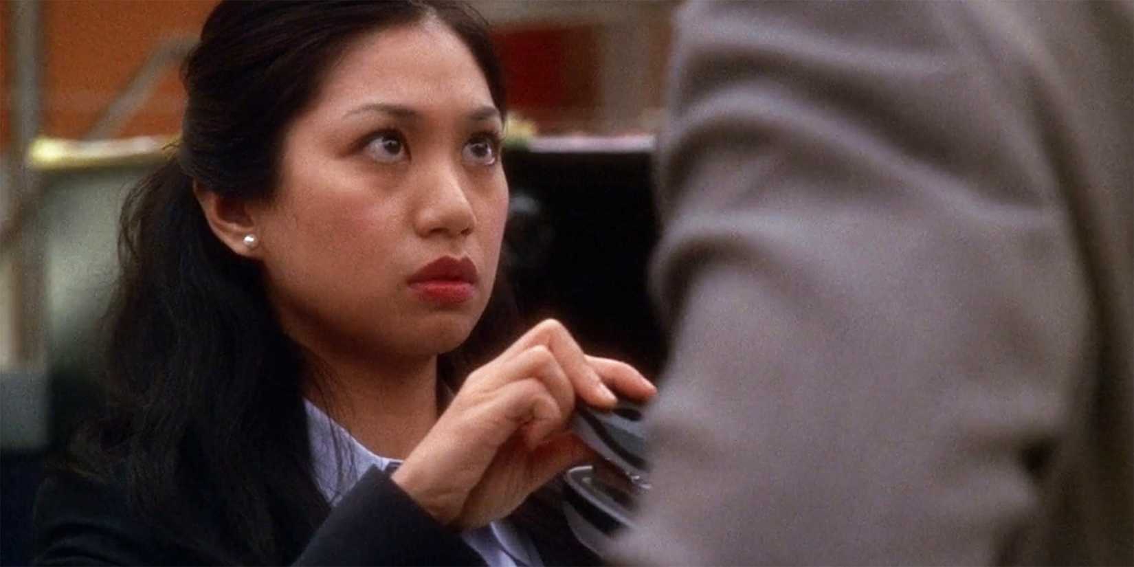 Special Agent Michelle Lee (Liza Lapira) looking up at someone in NCIS