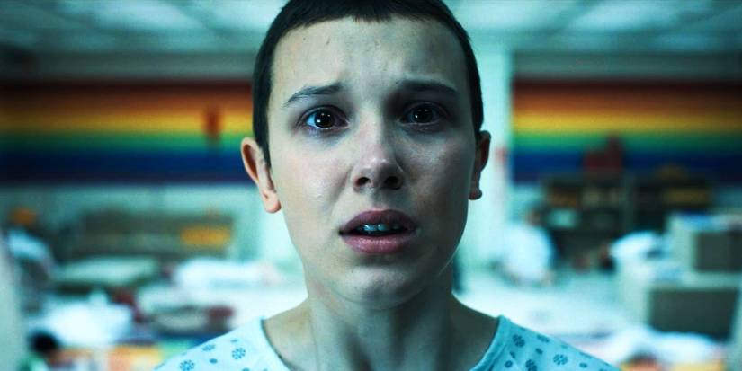 Eleven is looking distressed while looking at the mirror in Stranger Things