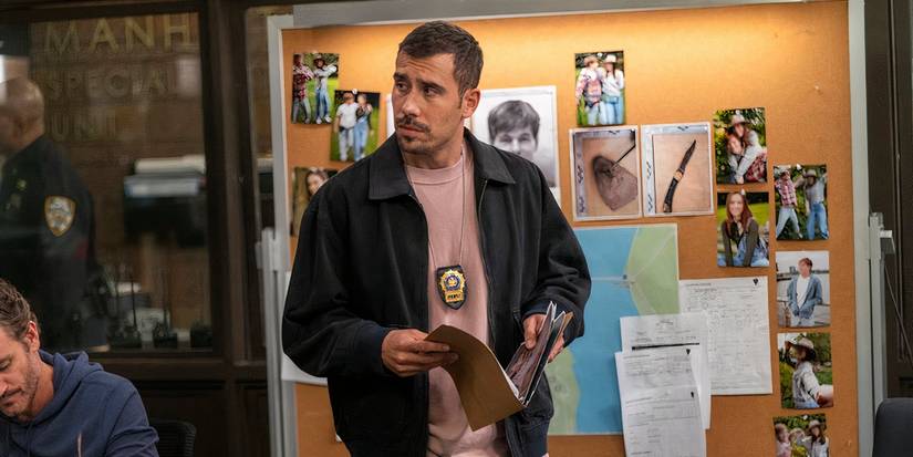 Law & Order: SVU Velasco holding a case file and standing in front of the board