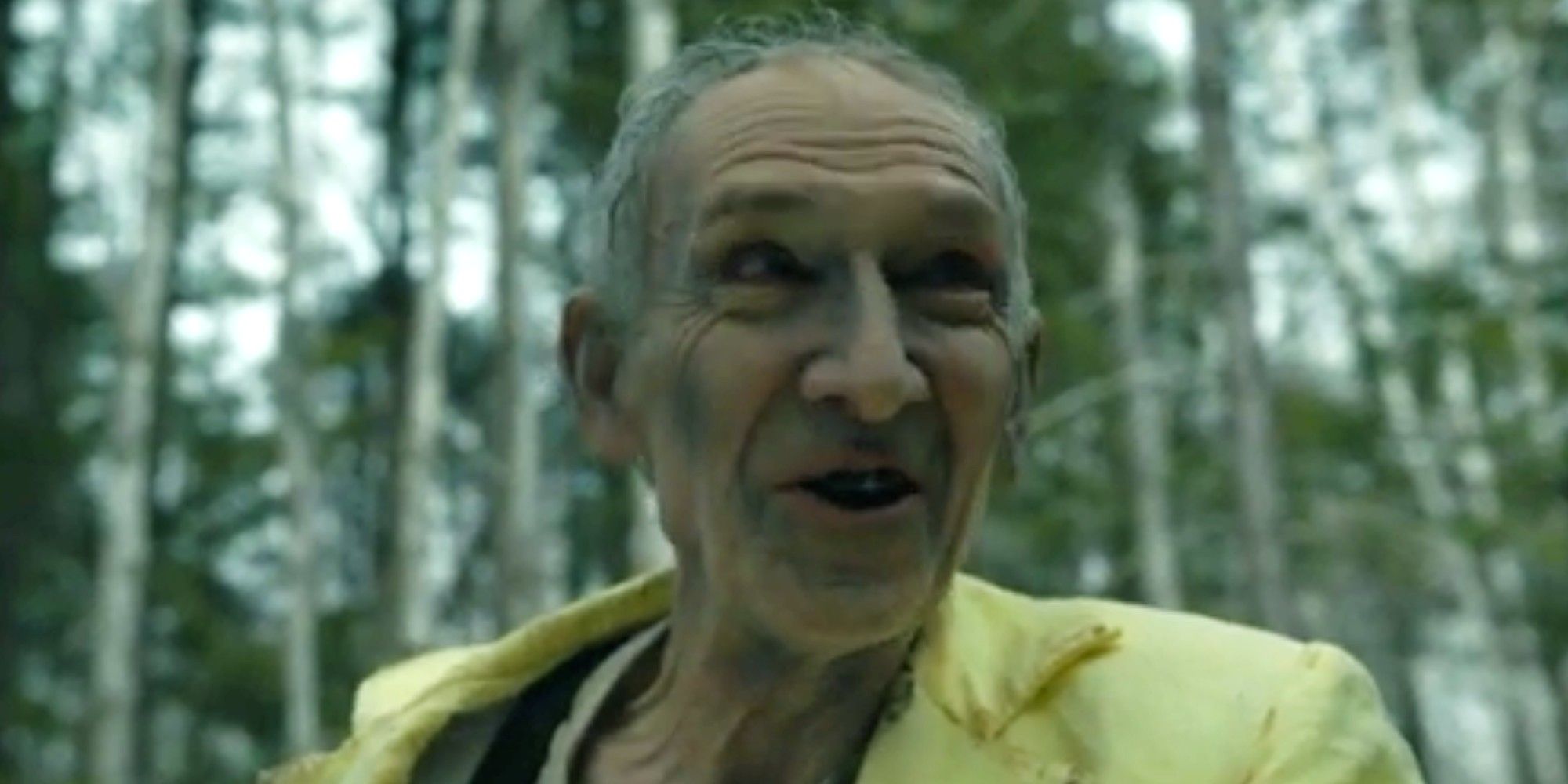 The Man in Yellow smiling in the forest in From season 3 finale