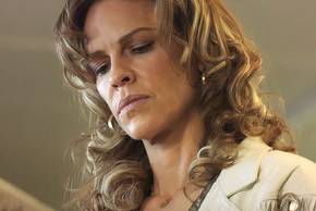 Hilary Swank reading something as Sharon in Ordinary Angels