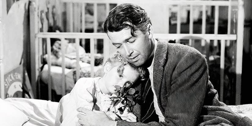 Джордж Бейли держит ребенка в фильме *It's A Wonderful Life*