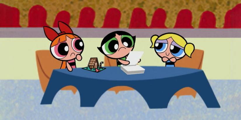The Powerpuff Girls sitting at a table looking sad