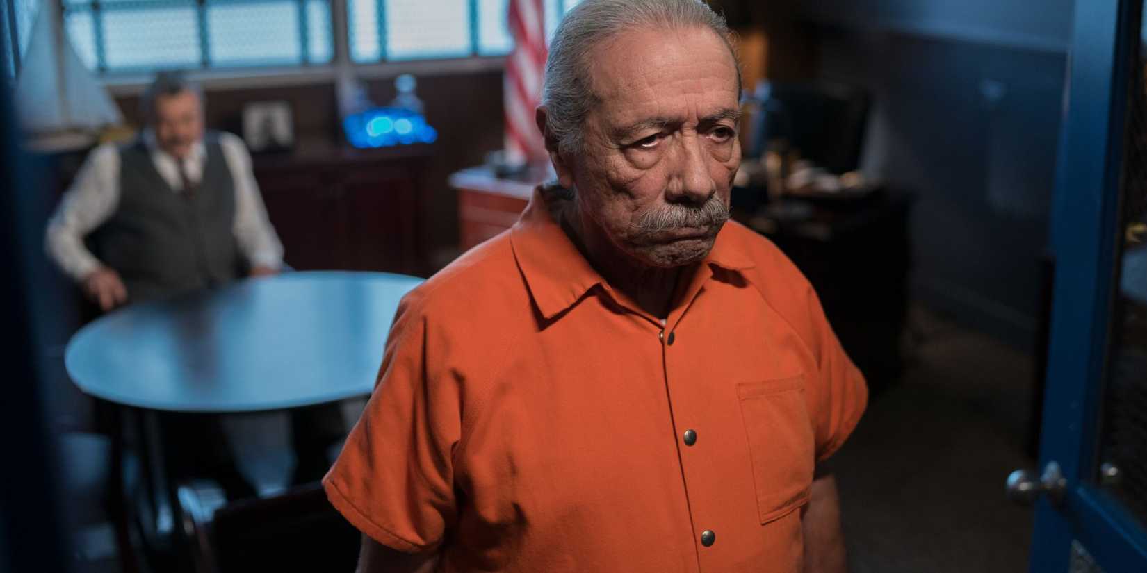 Blue Bloods Lorenzo Baptisa (Edward James Olmo) with his back to Frank, who is sitting at a prison visiting table