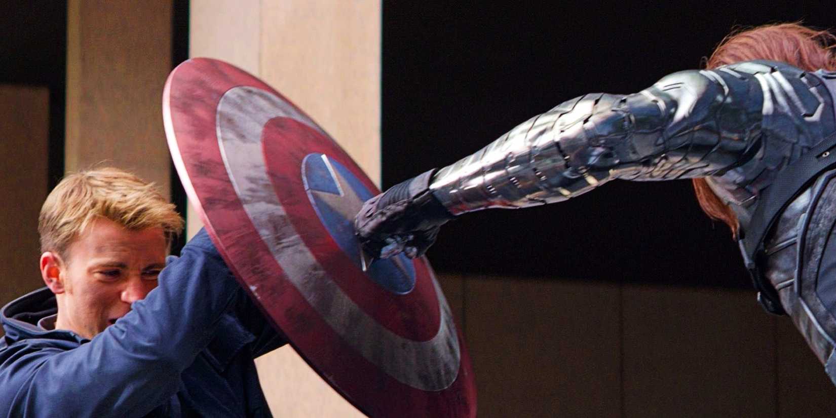 Chris Evans As Steve Rogers Braces The Captain America Shield While Bucky Barnes Punches It In Captain America The Winter Soldier