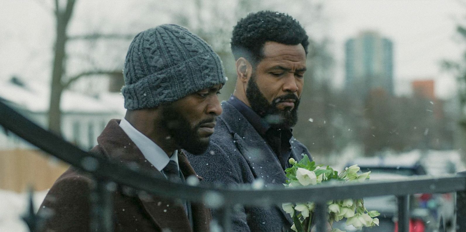 Alex (Aldis Hodge) and John (Isaiah Mustafa) bring flowers to Maria's grave in Cross Season 1