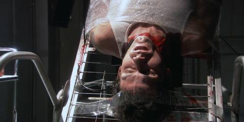 Brian Moser (Christian Camargo) hanging dead upside down with his throat slit in Dexter season 1, episode 12