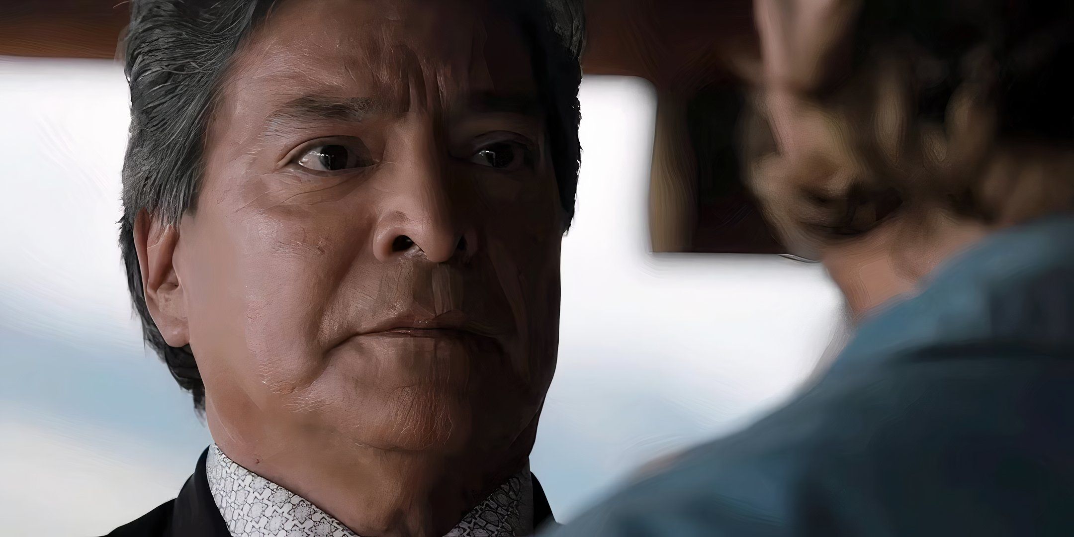 Gil Birmingham as Thomas Rainwater looking seriously at Luke Grimes' Kayce in the Yellowstone series finale