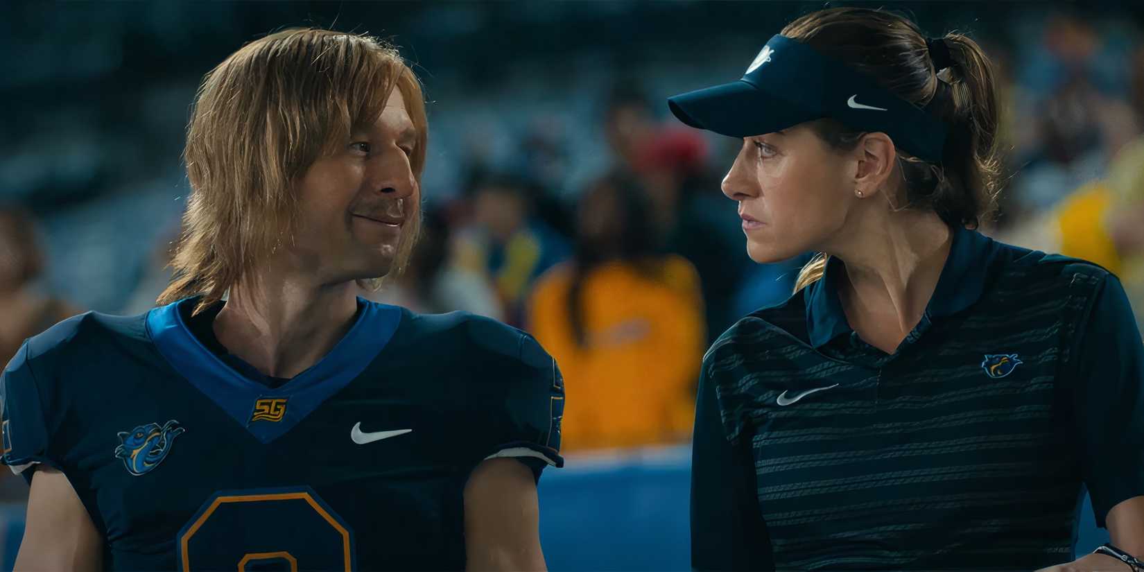Glen Powell's Chad smiling at a woman on the sideline in Chad Powers