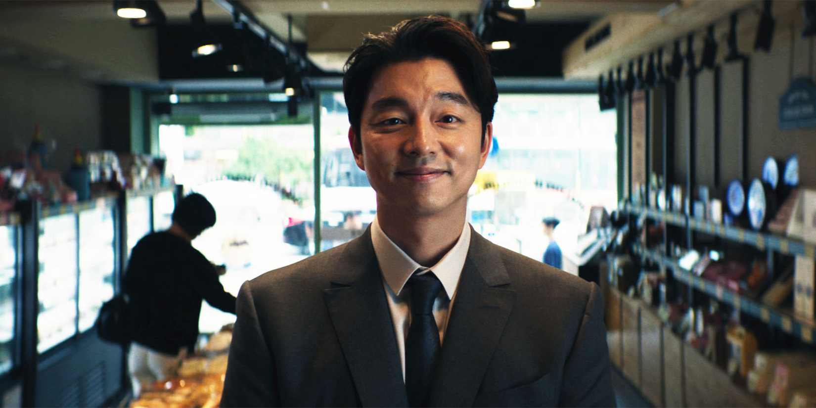 Gong Yoo smiling in Squid Game season 2 as The Recruiter