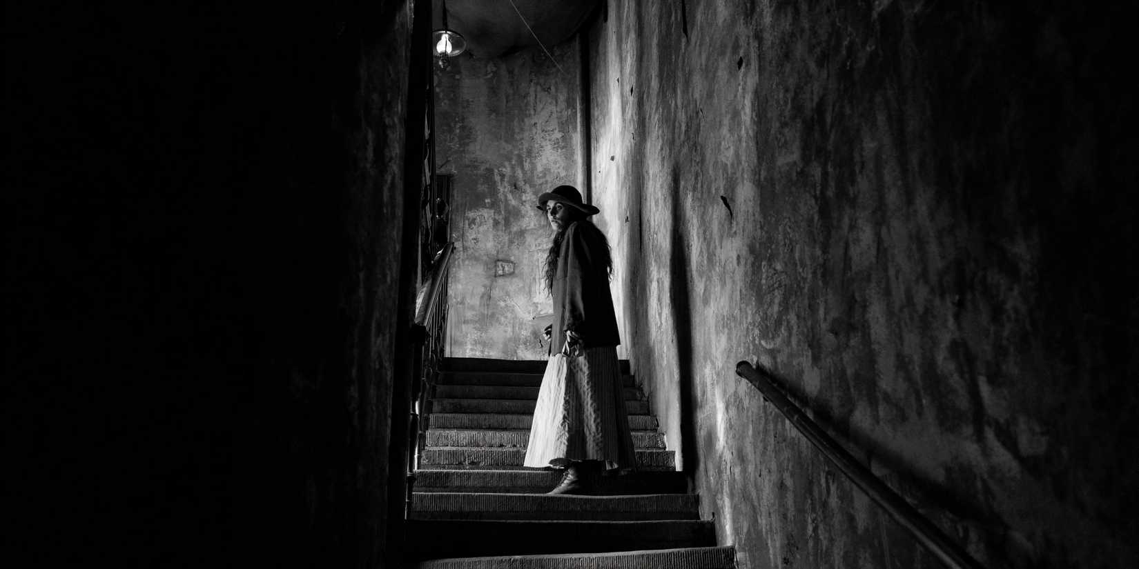 Karoline on the stairs in The Girl with the Needle