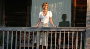 Kelly Reilly as Beth Dutton standing on the porch in Yellowstone season 5 episode 14