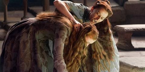 Lysa Arryn (Kate Dickie) holding Sansa's (Sophie Turner) head over the Moon Door in Game of Thrones